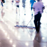 Houston commercial cleaning services worker dusting floor during working hours