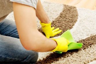 Janitorial worker cleaning commercial carpet stains