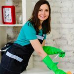 Green cleaning worker dusting